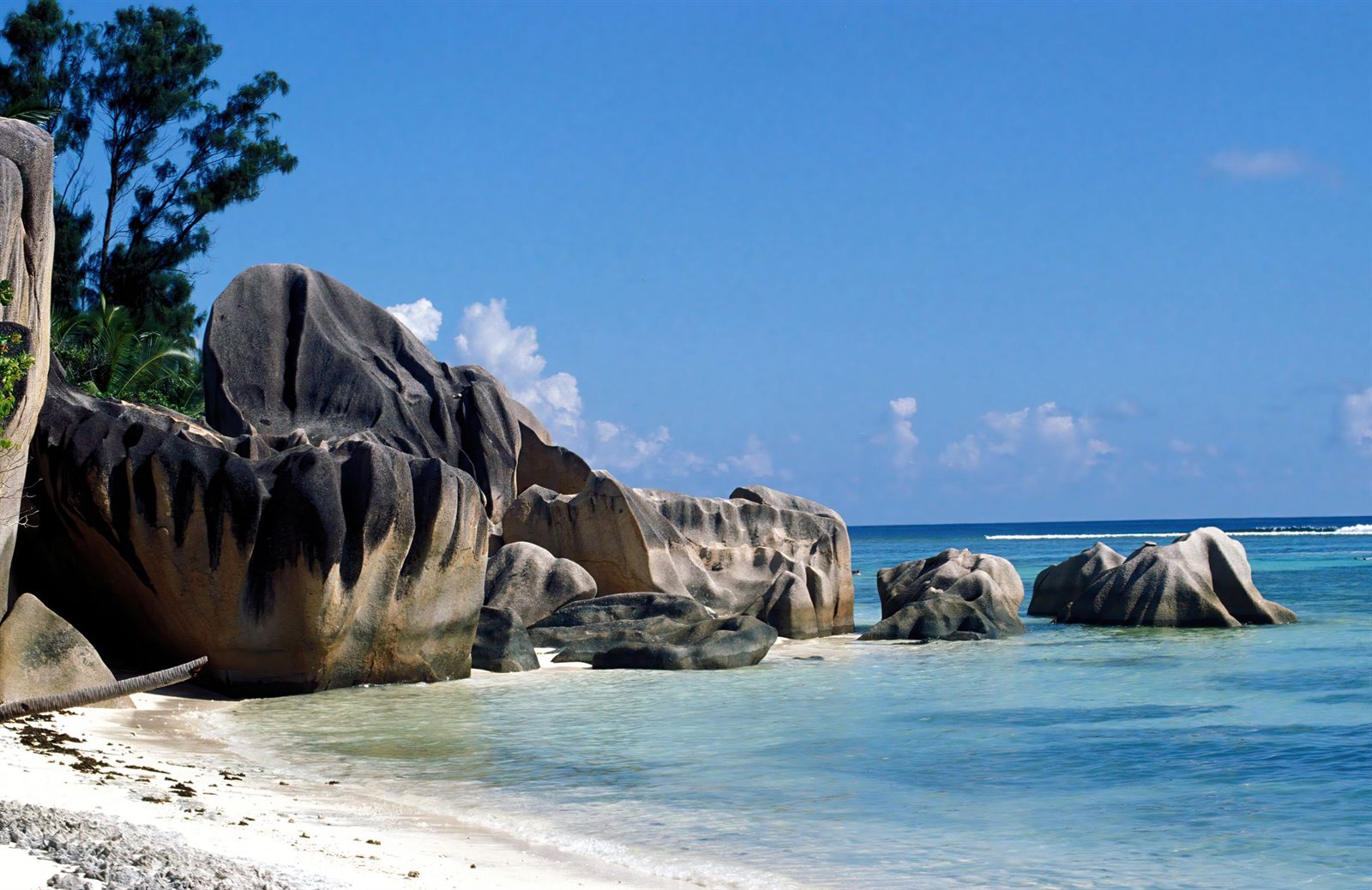Smooth granite boulders on a white-sand beach in the Seychelles
