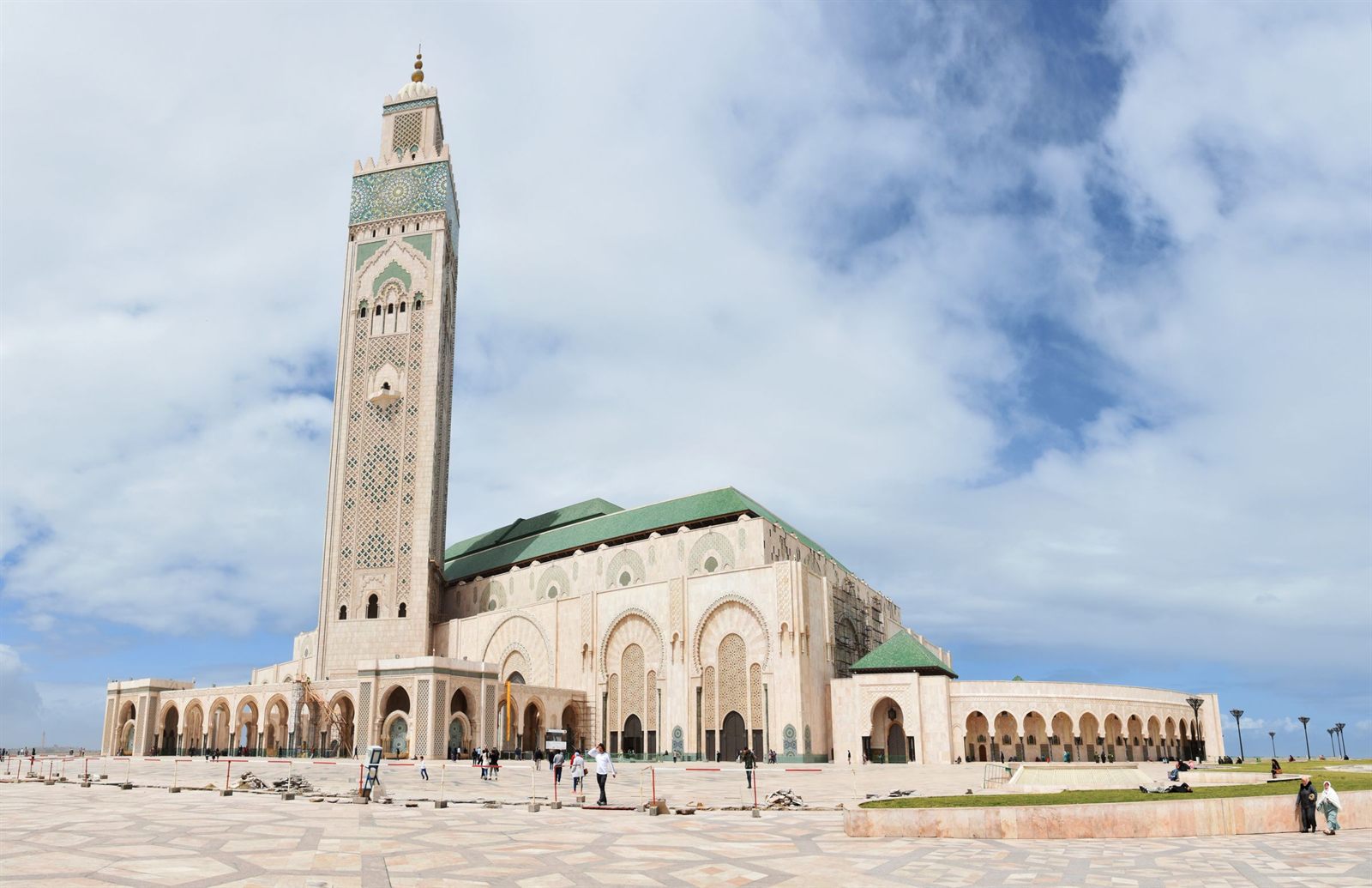 Tall minaret of the Hassan II Mosque in Casablanca under a cloudy sky
